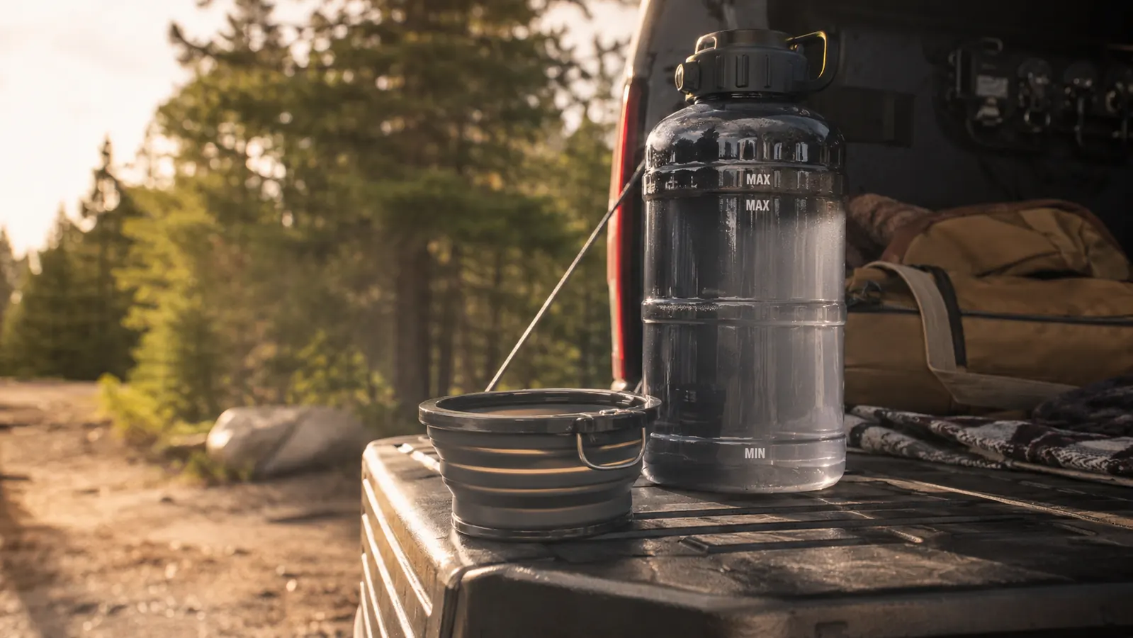 A dog travel water bottle tucked in a pickup truck door pocket beside a leash